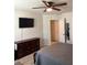 Bedroom featuring a ceiling fan, flat screen tv, and a dresser with carpet flooring at 860 Point Place Dr, Loganville, GA 30052