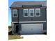 Modern two-story townhouse with a two car garage and manicured lawn at 860 Point Place Dr, Loganville, GA 30052