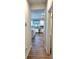 Hallway leading to a modern kitchen, with light hardwood floors at 860 Point Place Dr, Loganville, GA 30052