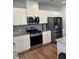 Modern kitchen featuring stainless steel appliances and granite countertops at 860 Point Place Dr, Loganville, GA 30052