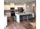 Open concept kitchen with an island, stainless steel appliances and pendant lighting at 860 Point Place Dr, Loganville, GA 30052