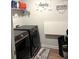 A functional laundry room featuring modern washer and dryer units, paired with a convenient folding area at 860 Point Place Dr, Loganville, GA 30052