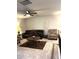 Inviting living room showcasing a dark leather couch, decorative rug, ceiling fan, and a cozy armchair at 860 Point Place Dr, Loganville, GA 30052