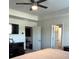 Bright main bedroom with a tray ceiling, ceiling fan, and two doorways at 860 Point Place Dr, Loganville, GA 30052