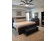 Spacious main bedroom with a tray ceiling, ceiling fan, and comfortable furniture at 860 Point Place Dr, Loganville, GA 30052