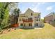 Backyard of a home with a lawn, patio, deck and trees at 3819 Meandering Sw Way, Lilburn, GA 30047