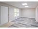 Basement room with wood-look flooring, a bright window, and an exterior door at 3819 Meandering Sw Way, Lilburn, GA 30047