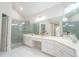 Elegant bathroom with glass-enclosed shower, double vanity, and ample counter space at 3819 Meandering Sw Way, Lilburn, GA 30047