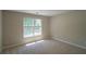 Bright bedroom featuring neutral walls, carpet, and natural light from a window with blinds at 3819 Meandering Sw Way, Lilburn, GA 30047