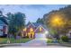 Traditional brick home with a two-car garage, well-lit entryway, and manicured front lawn at 3819 Meandering Sw Way, Lilburn, GA 30047