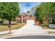 Charming two-story brick home with a well-manicured lawn and a long driveway at 3819 Meandering Sw Way, Lilburn, GA 30047