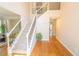 Bright foyer with hardwood floors and an elegant staircase with decorative iron railings at 3819 Meandering Sw Way, Lilburn, GA 30047
