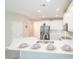 Modern white kitchen with stainless steel appliances and a center island with seating at 3819 Meandering Sw Way, Lilburn, GA 30047