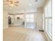 Open-concept living room with large windows and a view to the kitchen and dining area at 3819 Meandering Sw Way, Lilburn, GA 30047