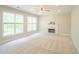 Spacious living room with plush carpet, fireplace, and large windows providing ample natural light at 3819 Meandering Sw Way, Lilburn, GA 30047