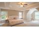 Spacious main bedroom with tray ceiling, soft colors, and multiple windows with views at 3819 Meandering Sw Way, Lilburn, GA 30047