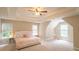 Bright main bedroom features tray ceiling, neutral tones, and ample natural light through multiple windows at 3819 Meandering Sw Way, Lilburn, GA 30047