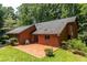 Brick home with brick patio and lush green trees surrounding the property at 5325 Pheasant Run, Stone Mountain, GA 30087