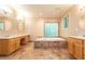 A spa-like bathroom with a soaking tub, double vanities, and large decorative mirrors at 5325 Pheasant Run, Stone Mountain, GA 30087