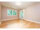 Bright bedroom with hardwood floors, large windows, and a door that leads to a private outdoor space at 5325 Pheasant Run, Stone Mountain, GA 30087