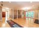 Open living area with hardwood floors, decorative columns, a chandelier, and access to the backyard at 5325 Pheasant Run, Stone Mountain, GA 30087