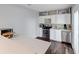 Modern kitchenette features sleek white cabinetry, stainless steel appliances, and a breakfast bar at 105 Grogans Lake Dr, Atlanta, GA 30350