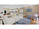 Open concept living room with hardwood floors, white couch, and view into the kitchen at 105 Grogans Lake Dr, Atlanta, GA 30350