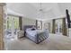 Spacious main bedroom with a tray ceiling, plush carpet, and a private door to a deck at 105 Grogans Lake Dr, Atlanta, GA 30350