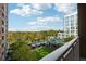 Scenic balcony view overlooking a serene landscape featuring lush greenery, a swimming pool, and nearby buildings at 1820 Peachtree Nw St # 804, Atlanta, GA 30309