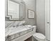 Elegant powder room featuring marble countertop and sophisticated mirror, adding a touch of luxury to the space at 1820 Peachtree Nw St # 804, Atlanta, GA 30309