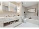 Luxurious bathroom featuring a double vanity, soaking tub, and modern fixtures at 1820 Peachtree Nw St # 804, Atlanta, GA 30309