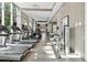 Well-equipped gym featuring modern treadmills and weight machines with large windows offering outdoor views at 1820 Peachtree Nw St # 804, Atlanta, GA 30309