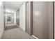 Well-lit hallway with neutral carpet and professionally designed accent walls leading to apartment doors at 1820 Peachtree Nw St # 804, Atlanta, GA 30309