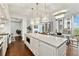 Open-concept kitchen and living area with granite countertops, modern lighting, and balcony access at 1820 Peachtree Nw St # 804, Atlanta, GA 30309