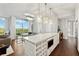 Spacious kitchen with a large island, wine rack, stainless appliances, and open living area beyond at 1820 Peachtree Nw St # 804, Atlanta, GA 30309