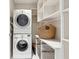 Well-organized laundry room with stacked washer and dryer, offering ample storage solutions and convenience at 1820 Peachtree Nw St # 804, Atlanta, GA 30309
