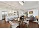 Open-concept living room featuring a modern kitchen, dining area, and comfortable seating around a fireplace at 1820 Peachtree Nw St # 804, Atlanta, GA 30309