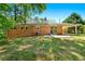 Brick home exterior with sliding glass doors leading to a patio and expansive green backyard at 2262 Hurt Sw Rd, Marietta, GA 30008