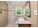 Bathroom with tiled shower, vanity with stone countertop, and natural light at 2262 Hurt Sw Rd, Marietta, GA 30008