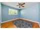 Bedroom with hardwood floors, a ceiling fan, and a large window at 2262 Hurt Sw Rd, Marietta, GA 30008