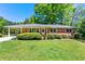 Charming brick home with well-manicured lawn, carport and lush landscaping at 2262 Hurt Sw Rd, Marietta, GA 30008