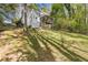 Large, grassy backyard with mature trees and a fenced perimeter offering privacy at 2315 Fisher Dr, Loganville, GA 30052