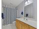 Bright bathroom featuring a shower/tub combo with a blue and white patterned shower curtain at 2315 Fisher Dr, Loganville, GA 30052