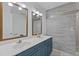 Elegant bathroom with dual sinks, gray tiled accent wall, and modern fixtures at 2315 Fisher Dr, Loganville, GA 30052