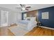 Spacious bedroom featuring a wood accent wall, hardwood floors, and a ceiling fan at 2315 Fisher Dr, Loganville, GA 30052