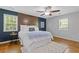 Comfortable bedroom with hardwood floors, wood accent wall, and natural light at 2315 Fisher Dr, Loganville, GA 30052