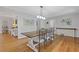 Bright dining room featuring hardwood floors, modern lighting, and a large table with seating for six at 2315 Fisher Dr, Loganville, GA 30052