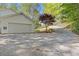 A large driveway leads to an attached garage, complemented by a mature red-leafed tree at 2315 Fisher Dr, Loganville, GA 30052