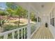 Relaxing front porch with white railings and wooden floors, perfect for enjoying the serene outdoor views at 2315 Fisher Dr, Loganville, GA 30052