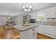 Well-lit kitchen with a center island, modern appliances, and a view into the dining area at 2315 Fisher Dr, Loganville, GA 30052